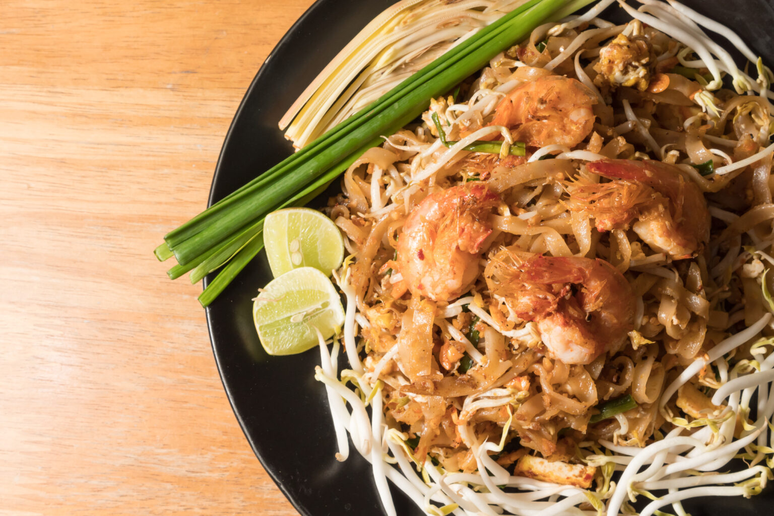 Close up plate of Padthai, Thai noodle with fried shrimp and vegetable,Thai Food, Thailand's national dishes.